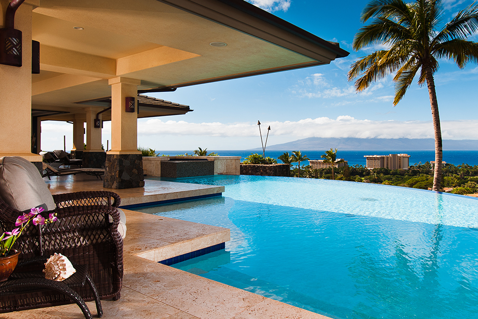 A magnificent pool view at a luxury vacation home overlooking the ocean. Over 2,000 vacation homes at your fingertips. 